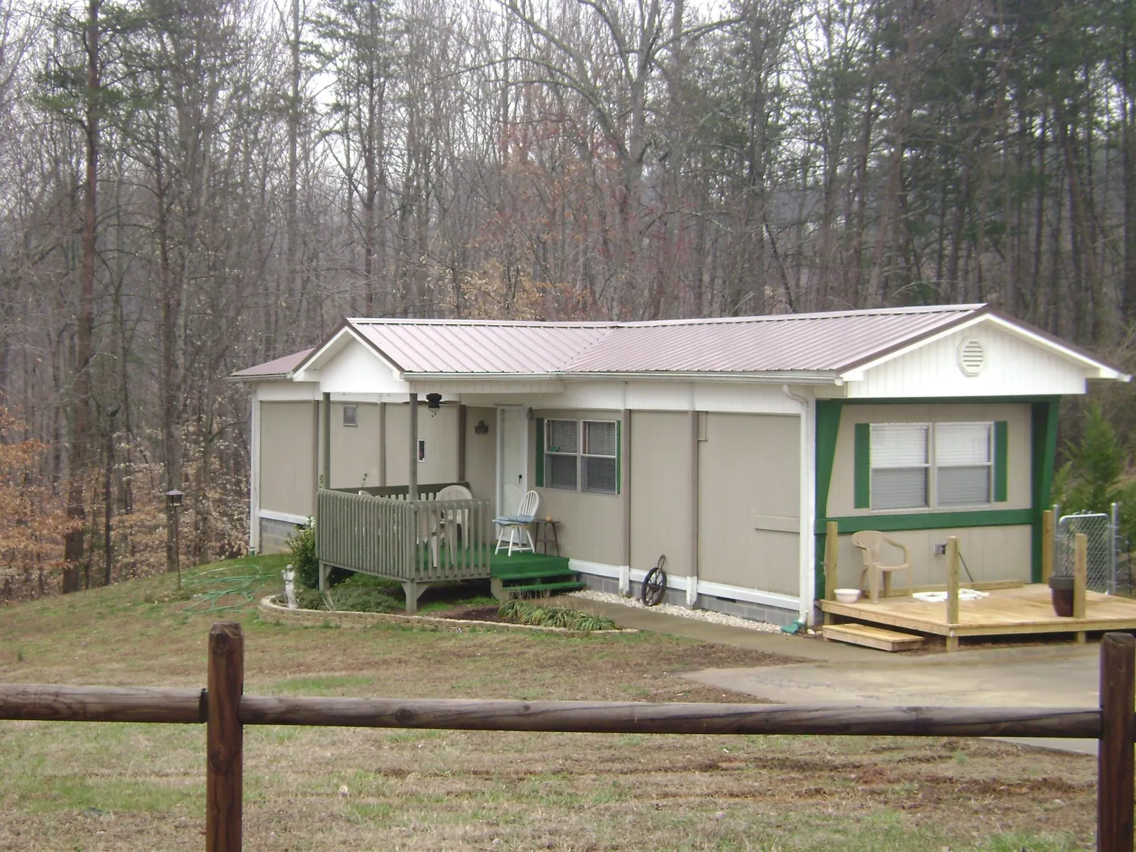 Mauve metal roof on a manufactured home with a new front deck in Holly Bluff